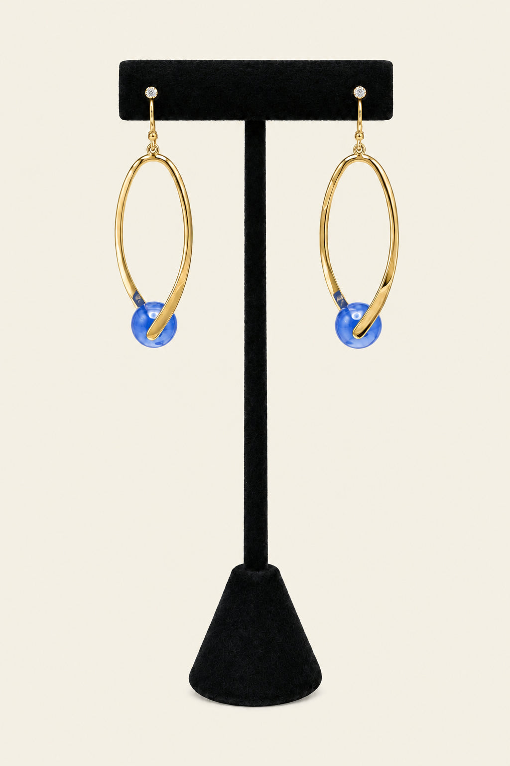 Gold tone drop earrings with blue bead